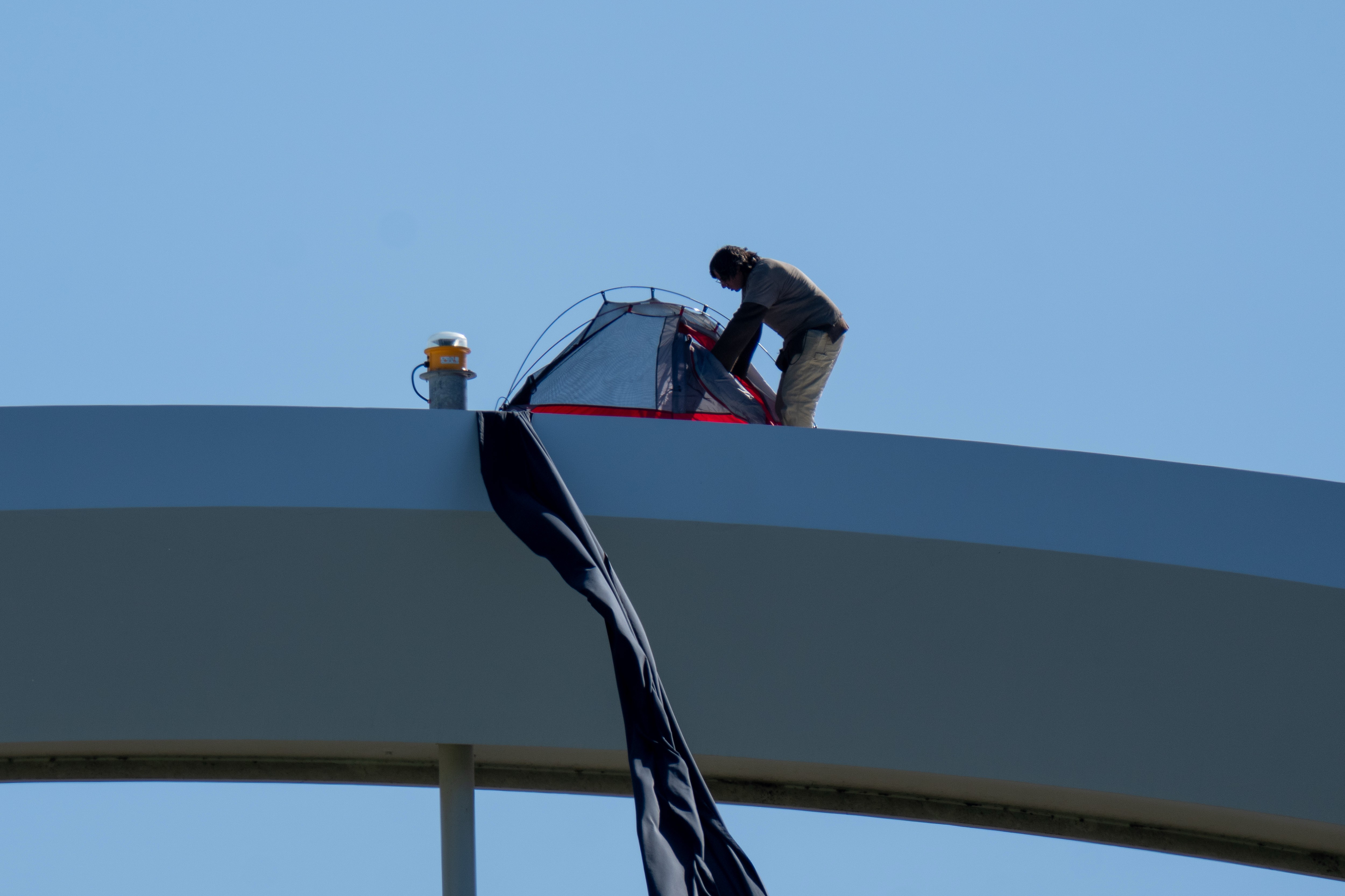 Homem escala ponte em Washington por 6 horas em protesto contra Trump, guerra e IA